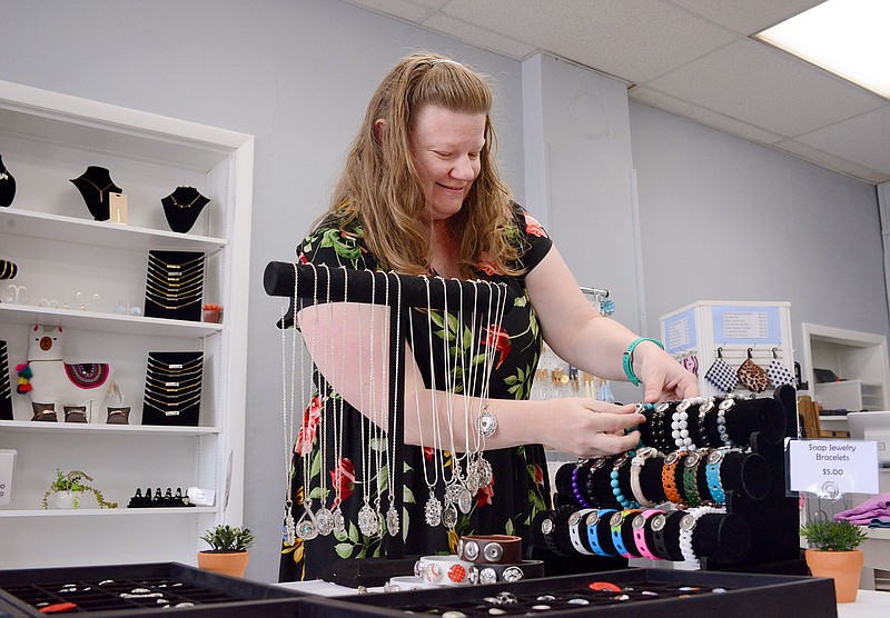 Sally Ince/News TribuneOwner Sheila Bernhorst attaches a snap charm to design a bracelet Wednesday at Mattie Grace Boutique on Jefferson Street. 