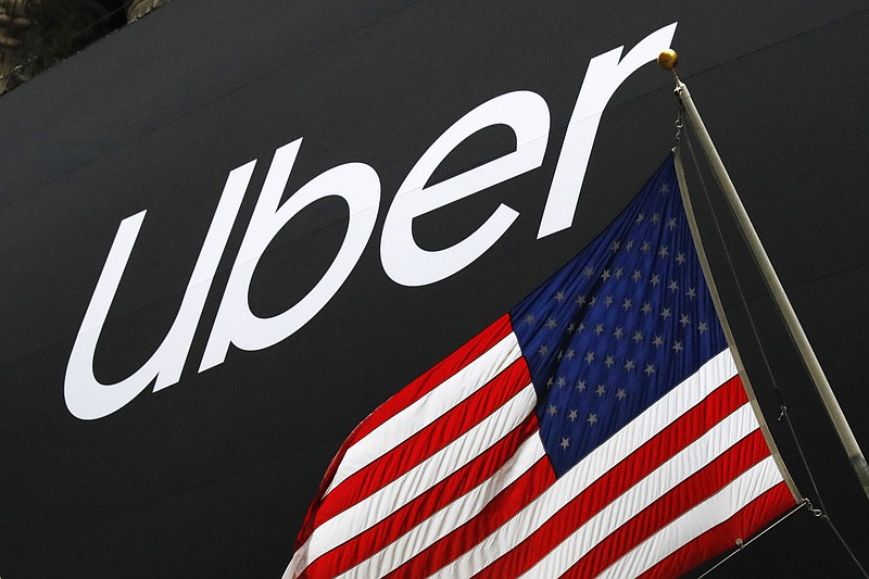 FILE - In this May 10, 2019, file photo a banner for Uber is draped on the front of the New York Stock Exchange before the world's largest ride-hailing service holds its initial public offering. Uber is letting passengers request a more comfortable ride if they’re willing to pay. The ride-hailing giant launched “comfort” rides Tuesday, July 9.  (AP Photo/Mark Lennihan, File)