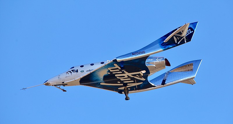 FILE - In this Dec. 13, 2018 file photo, a view of Virgin Galactic prior to it reaching space for the first time during its 4th powered flight from Mojave, Calif. Richard Branson’s space-tourism venture, Virgin Galactic, is planning to go public, creating the first publicly listed human spaceflight firm, it was reported on Tuesday, July 9, 2019. Virgin Galactic is merging with Social Capital Hedosophia, whose CEO, Chamath Palihapitiya, will become chairman of the combined entity. The value of the merger was put at $1.5 billion. (AP Photo/Matt Hartman, File)