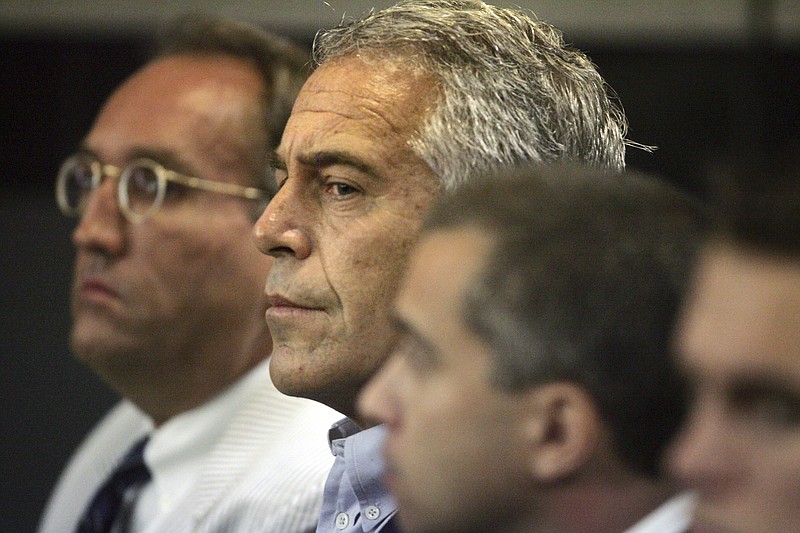 FILE - In this July 30, 2008, file photo, Jeffrey Epstein, center, appears in court in West Palm Beach, Fla. The wealthy financier pleaded not guilty in federal court in New York on Monday, July 8, 2019, to sex trafficking charges following his arrest over the weekend. Epstein will have to remain behind bars until his bail hearing on July 15. (Uma Sanghvi/Palm Beach Post via AP, File)