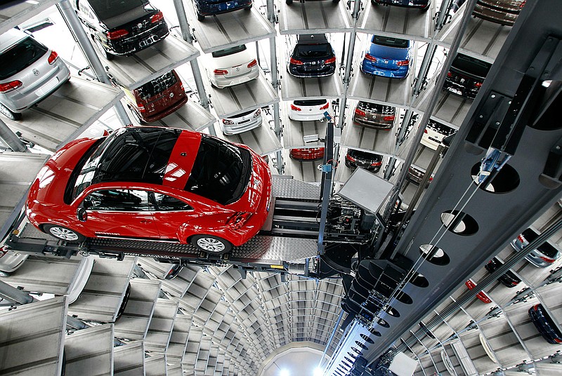 In this March 12, 2012, file photo a Volkswagen New Beetle car is lifted inside a delivery tower after the company's annual press conference in Wolfsburg, Germany. Volkswagen is halting production of the last version of its Beetle model in July 2019 at its plant in Puebla, Mexico, the end of the road for a vehicle that has symbolized many things over a history spanning eight decades since 1938. (AP Photo/Michael Sohn, File)