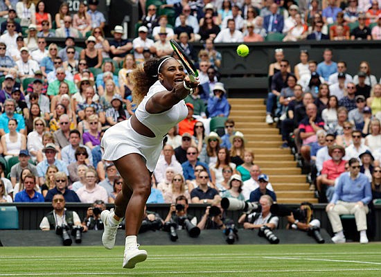 Serena Williams returns the ball to Alison Riske during their women's quarterfinal match Tuesday at Wimbledon in London.