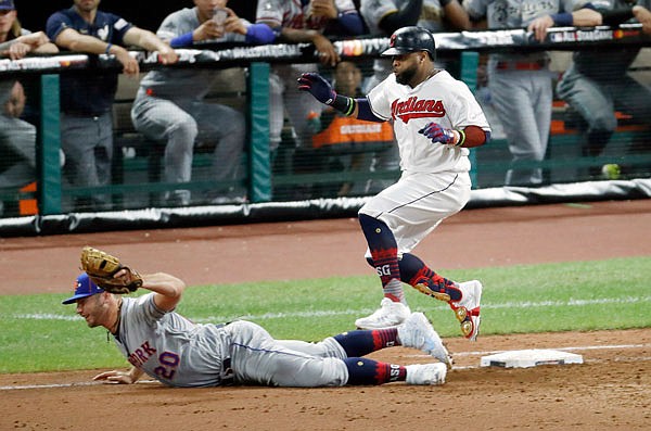 Carlos Santana of the American League is forced out by National League first baseman Pete Alonso during the sixth inning of the MLB All-Star Game on Tuesday in Cleveland.