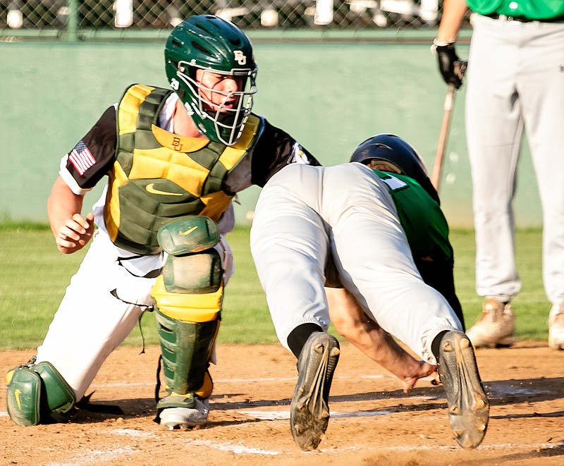 Texarkana Twins catcher Jake Walsh tags out a Baton Rouge Rougarou  at home plate Tuesday in a Texas Collegiate League game at George Dobson Field in Texarkana, Texas.