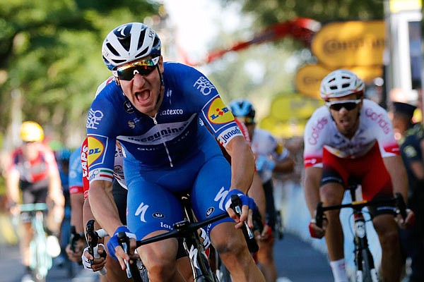 Elia Viviani celebrates Tuesday as he crosses the finish line to win the fourth stage of the Tour de France in Nancy, France.