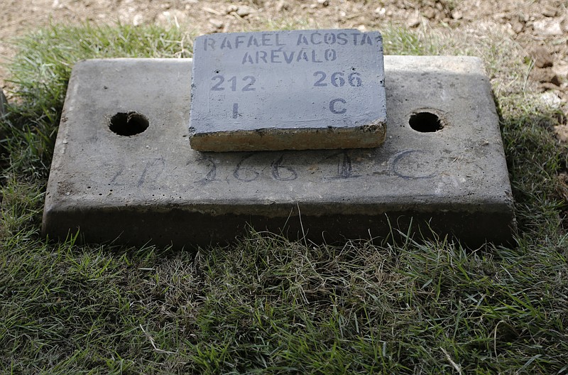 The tomb of Navy Captain Rafael Acosta lies at the East cemetery in Caracas, Venezuela, Wednesday July 10, 2019. Acosta, a Venezuelan navy captain who died of suspected torture while in government custody, was buried by authorities against the family's wishes to perform a private ceremony, an attorney and relatives said. (AP Photo/Leonardo Fernandez)
