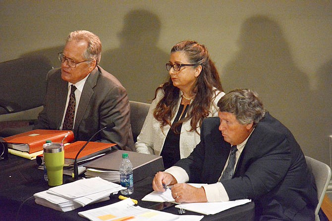 Tammy Ferry sits between her attorneys, David Moen, left, and Roger G. Brown, on July 10, 2019, during her hearing before the JC Schools Board of Education in the auditorium in the Miller Performing Arts Center. 