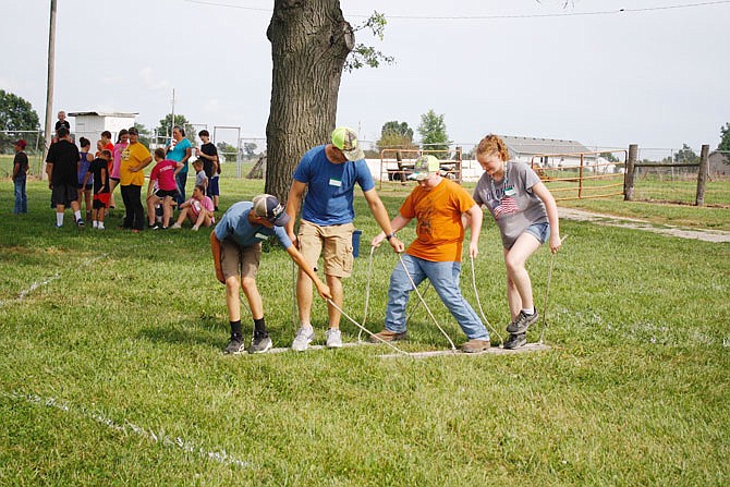 The team comprised of Reed Benne, Bryar Delashmutt, Case Rimert and Cassidy Murphy is shown. They competed Wednesday in the plank walk portion of the obstacle course during the "super farmer contest" at the seventh annual Callaway Youth Expo.