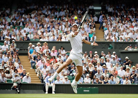 Novak Djokovic returns the ball to David Goffin during their quarterfinal match Wednesday at Wimbledon in London.