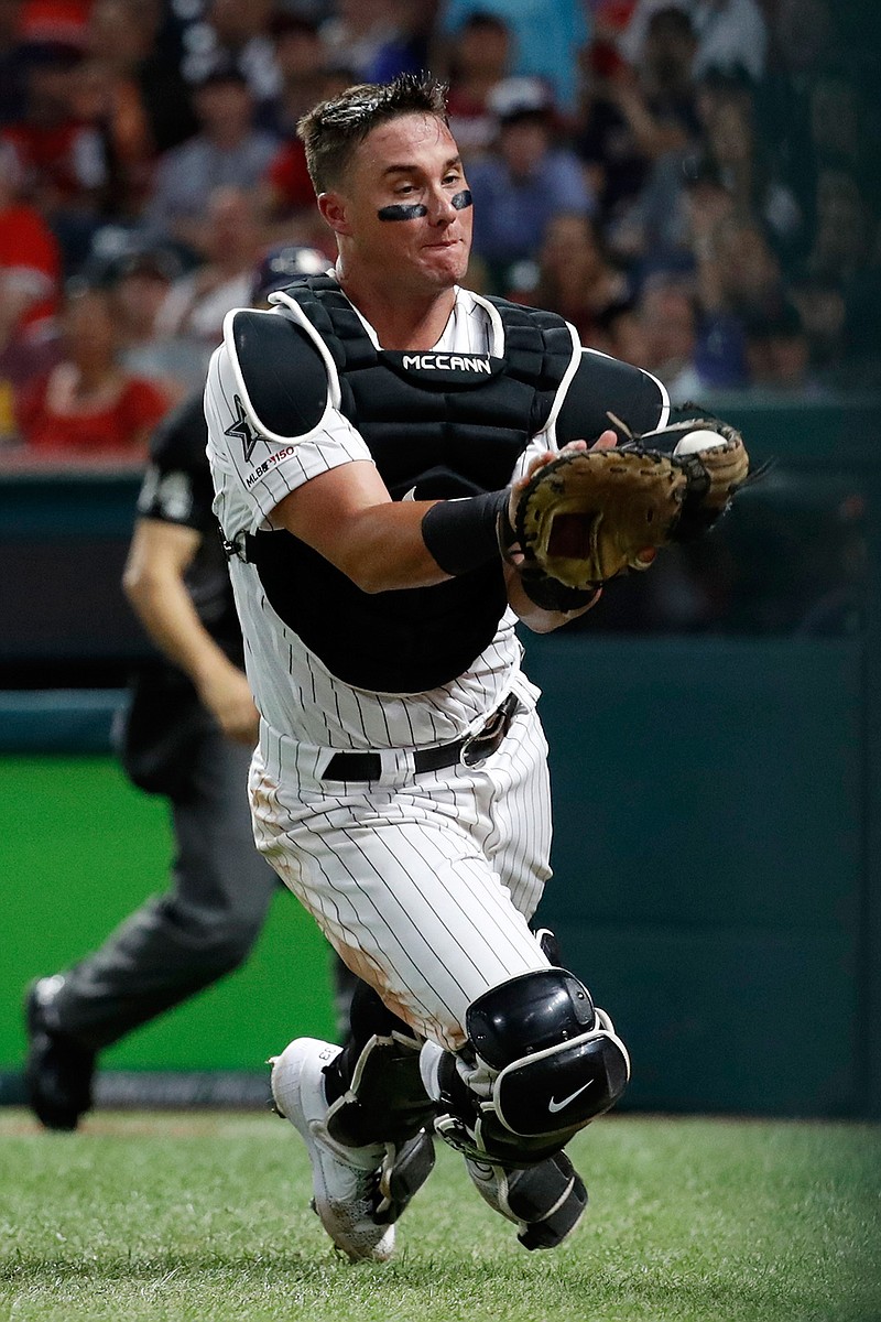 American League catcher James McCann, of the Chicago White Sox, catches pop up in foul territory by National League Mike Moustakas, of the Milwaukee Brewers, to end the top of the eighth inning of the MLB baseball All-Star Game, Tuesday, July 9, 2019, in Cleveland. (AP Photo/John Minchillo)