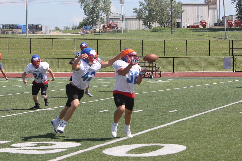 The California Pintos football team runs drills, including passing offensive ones, during a camp on July 11, 2019.