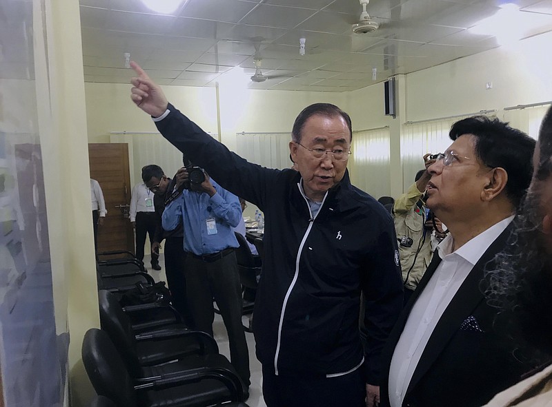 In this Wednesday, July 10, 2019 photo, former U.N. Secretary-General Ban Ki-moon, center, gestures as he is briefed by Bangladesh foreign minister A.K.Abdul Momen, right during avist to the Kutupalong Rohingya refugees camp in the southern coastal district of Cox's Bazar, Bangladesh. Ban has expressed concern that monsoon floods could threaten the lives of Rohingya refugees in sprawling camps in Bangladesh. (AP Photo/ Al-emrun Garjon)