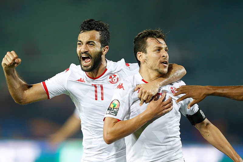 Tunisia's Youssef Msakni, right and Tunisia's Taha Khenissi celebrate after scoring during the African Cup of Nations quarterfinal soccer match between Madagascar and Tunisia in Al Salam stadium in Cairo, Egypt, Thursday, July 11, 2019. (AP Photo/Ariel Schalit)