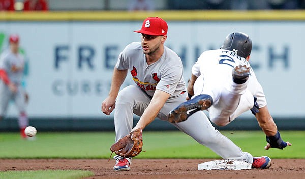 Cardinals shortstop Paul DeJong reaches for the ball before tagging out Dylan Moore of the Mariners at second on a stolen-base attempt during the second inning of a game last week in Seattle.