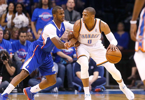 In this May 5, 2014, file photo, Thunder guard Russell Westbrook (right) drives against Clippers guard Chris Paul in the first quarter of Game 1 of a Western Conference semifinal playoff series in Oklahoma City. A person with knowledge of the situation said Thunder have traded Westbrook to the Rockets for Paul.