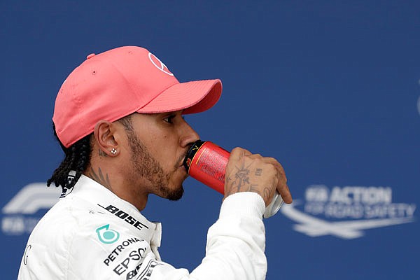 Mercedes driver Lewis Hamilton refreshes after Saturday's qualifying session at the Silverstone racetrack in Silverstone. The British Formula One Grand Prix will be held today.