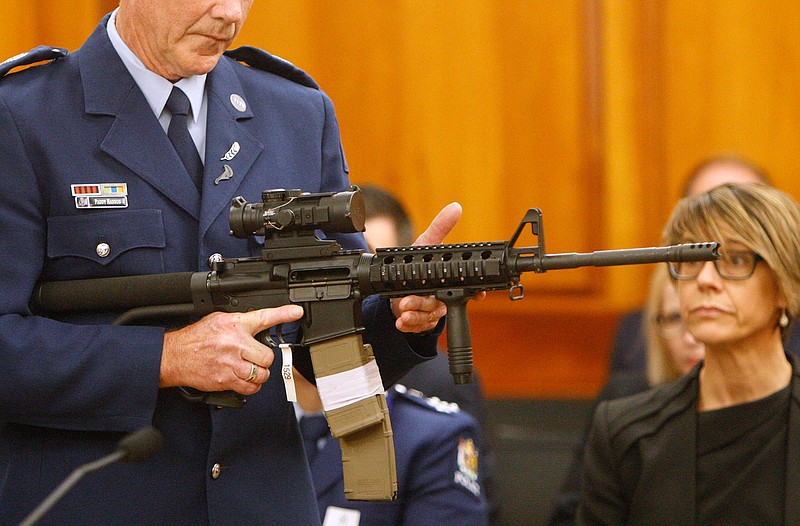  In this April 2, 2019, file photo, Police Sr. Sgt. Paddy Hannan shows New Zealand lawmakers an AR-15 style rifle similar to one of the weapons a gunman used to slaughter 50 people at two mosques, in Wellington, New Zealand. Dozens of Christchurch gun owners handed over their weapons in exchange for cash in the first of more than 250 planned buyback events around New Zealand after the government outlawed many types of semi-automatics. New Zealand lawmakers in April rushed through new legislation to ban so-called military-style weapons after a lone gunman killed 51 people at two Christchurch mosques in March. (AP Photo/Nick Perry, Fie)