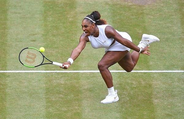 Serena Williams returns the ball to Simona Halep during Saturday's women's singles final match at the Wimbledon Championships in London.