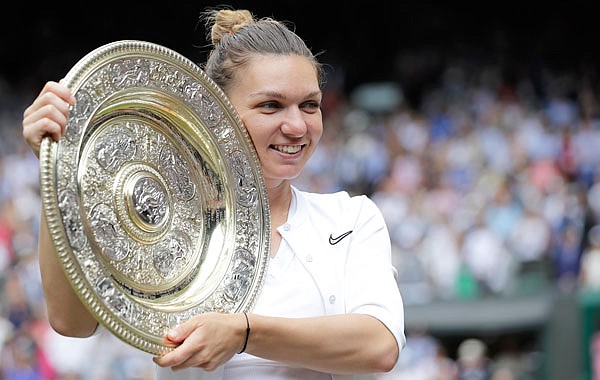 Simona Halep poses with the trophy after defeating Serena Williams during the women's singles final match Saturday at the Wimbledon Championships in London.