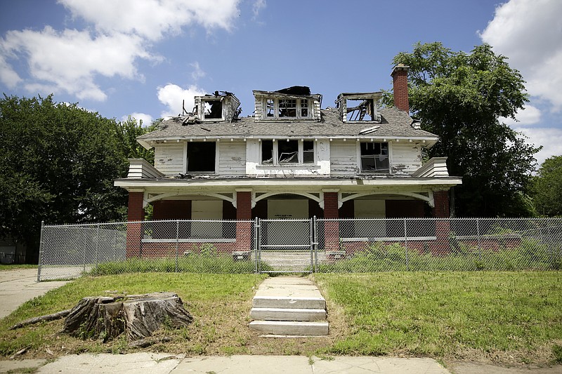 This Friday, July 12, 2019 photo, shows the fire-damaged home of Satchel Paige, one of baseball's legendary pitchers and showmen, in Kansas City, Mo. A $150,000 grant to rehabilitate the home was one of 22 awarded by the National Trust for Historic Preservation to help preserve black history. (AP Photo/Charlie Riedel)