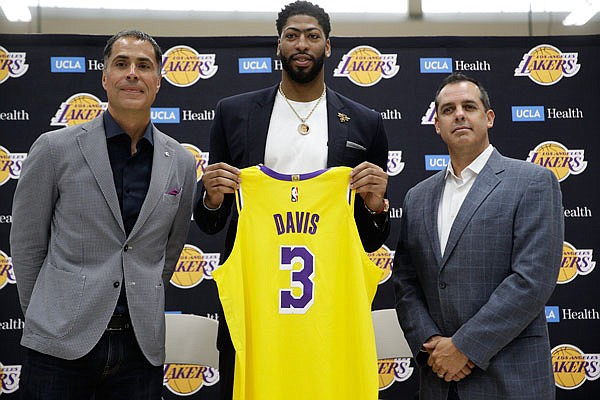 Lakers general manager Rob Pelinka (left) and head coach Frank Vogel (right) introduce Anthony Davis at a news conference Saturday at the UCLA Health Training Center in El Segundo, Calif.