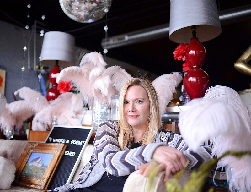 Owner Annie Schulte sits on an antique sofa Wednesday at the front of her Encore Department Store. Schulte used her store to help those in need after the May 22 tornado caused extensive damage to the area. 