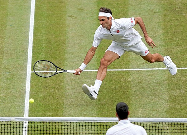Roger Federer returns the ball to Novak Djokovic during Sunday's men's singles final match of the Wimbledon Championships in London.