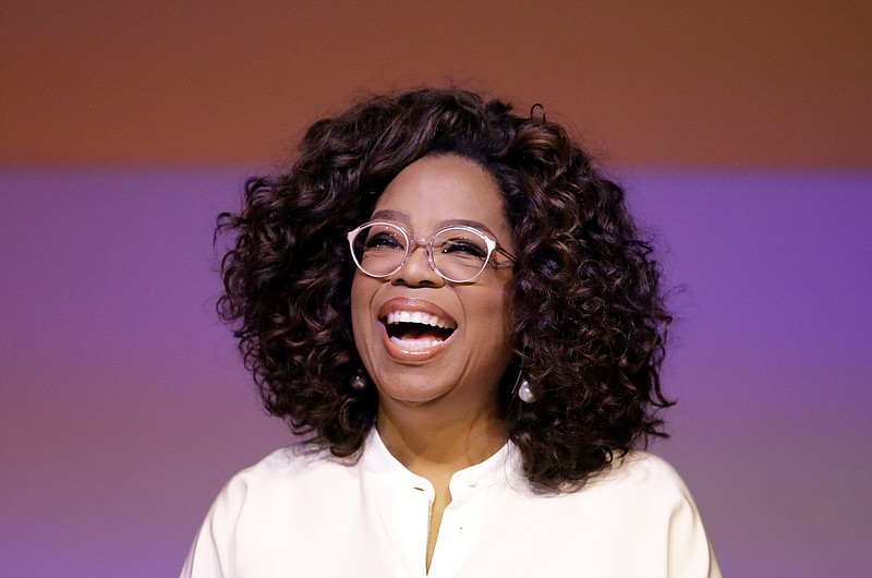 FILE - In this Nov. 29, 2018 file photo, Oprah Winfrey smiles during a tribute to Nelson Mandela and promoting gender equality event at University of Johannesburg in Soweto, South Africa.  (AP Photo/Themba Hadebe, File)