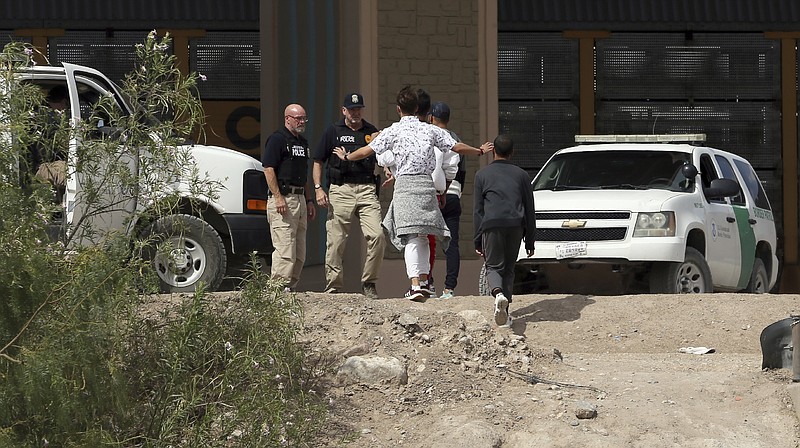 FILE - In this July 4, 2019 file photo, a group of asylum seekers cross the border between El Paso, Texas, and Juarez, Chihuahua, Mexico, Thursday, July 4, 2019. (Mark Lambie/The El Paso Times via AP)