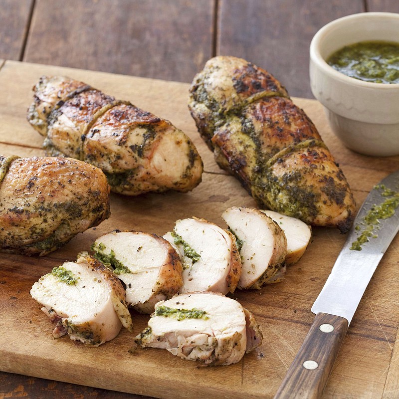 This undated photo provided by America's Test Kitchen in June 2019 shows Grilled Pesto Chicken  in Brookline, Mass. This recipe appears in the cookbook "Master of the Grill." (Joe Keller/America's Test Kitchen via AP)