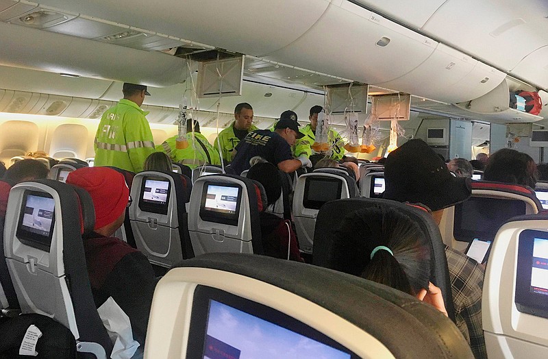 FILE - In this Thursday, July 11, 2019 photo provided by Tim Tricky of the band Hurricane Fall, emergency workers treat a passenger on an Air Canada flight to Australia that was diverted and landed at Daniel K. Inouye International Airport in Honolulu. The flight from Vancouver to Sydney encountered "un-forecasted and sudden turbulence," about two hours past Hawaii when the plane diverted to Honolulu, Air Canada spokeswoman Angela Mah said in a statement. Clear-air turbulence happens most often in or near the high-altitude rivers of air called jet streams. The culprit is wind shear, which is basically when two huge air masses close to each other are moving at different speeds. If the difference in speed is big enough, the atmosphere can't handle the strain, and it breaks into turbulent patterns like eddies in water. (Tim Tricky/Hurricane Fall via AP)