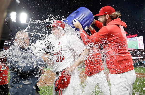 Cardinals starting pitcher Miles Mikolas is doused by teammate Michael Wacha while being interviewed by television reporter Jim Hayes after throwing a complete-game shutout Monday night against the Pirates at Busch Stadium.