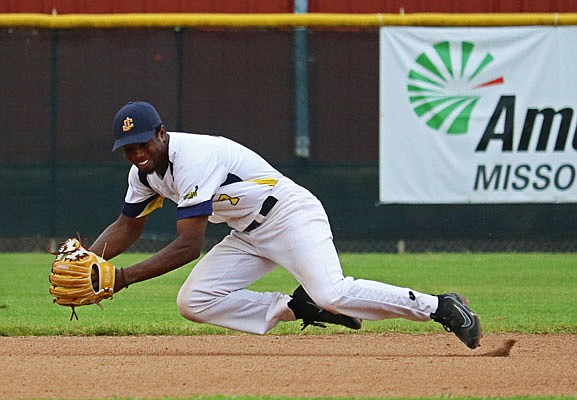 Renegades shortstop Dede Cole makes a diving stop during Monday night's game against Nevada at Vivion Field.