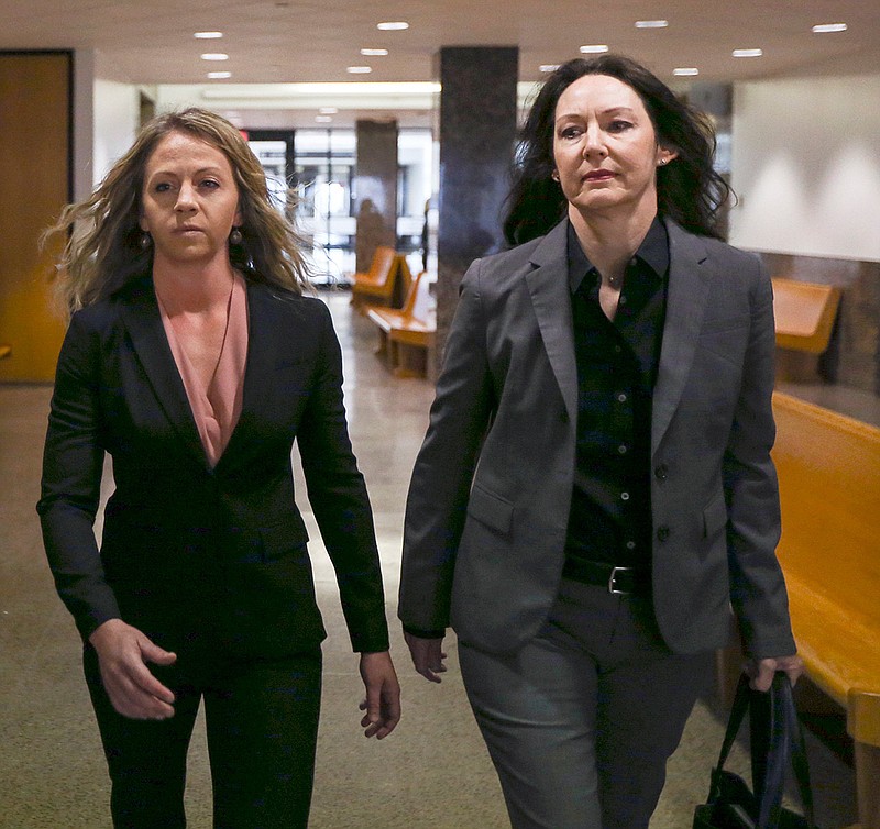 Former Dallas police officer Amber Guyger, left, walks the hallway June 6 at the Frank Crowley Courts Building in Dallas. Prosecutors have objected to Guyger's request that her murder trial for fatally shooting a neighbor in his own apartment be relocated.