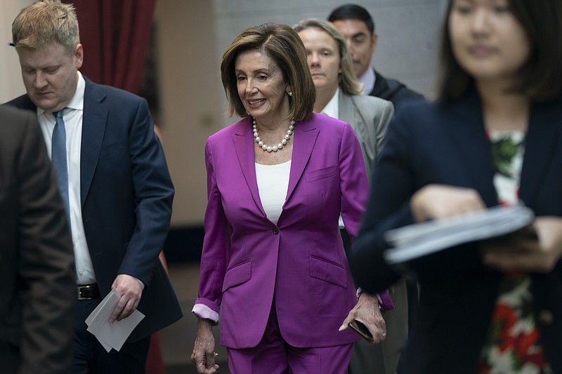 House Speaker Nancy Pelosi, D-Calif., arrives for a closed-door session with her caucus before a vote on a resolution condemning what she called "racist comments" by President Donald Trump at the Capitol in Washington, Tuesday, July 16, 2019. His remarks were directed at Reps. Ilhan Omar of Minnesota, Alexandria Ocasio-Cortez of New York, Ayanna Pressley of Massachusetts and Rashida Tlaib of Michigan. (AP Photo/J. Scott Applewhite)