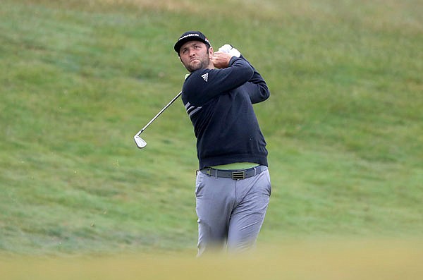 In this July 5 file photo, Jon Rahm watches the flight of his ball during the Irish Open at Lahinch Golf Club in Lahinch, Ireland.