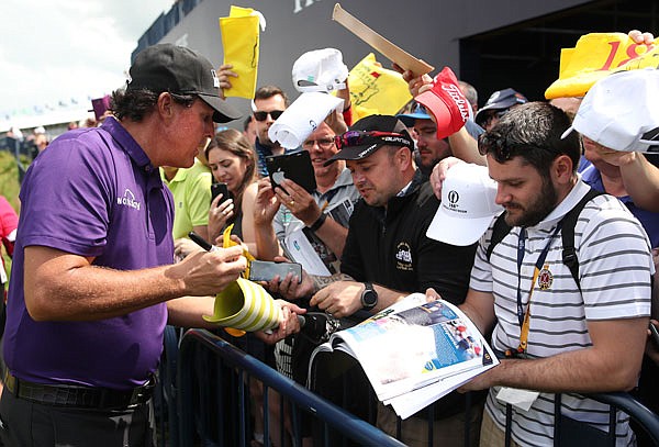 Phil Mickelson signs autographs on the 18th fairway during a practice round Tuesday ahead of the start of the British Open at Royal Portrush in Northern Ireland.