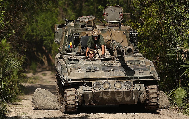 Reporter Patrick Connolly drives a tank at Tank America on June 27, 2019 in Melbourne, Fla. (Stephen M. Dowell/Orlando Sentinel/TNS) 