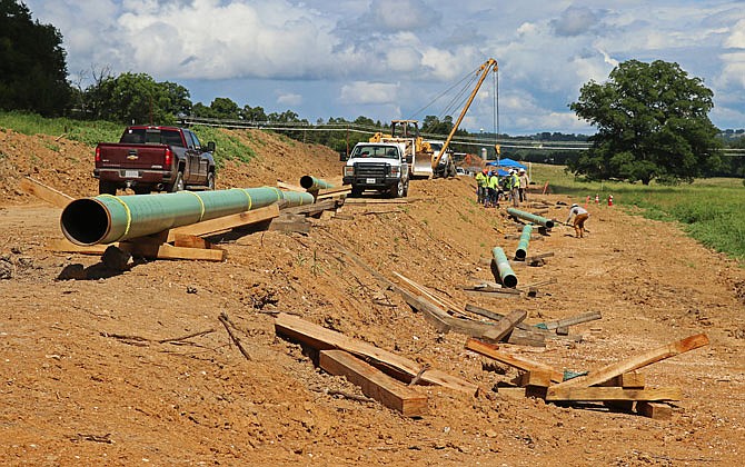 Todd Creason Construction employees weld pieces of pipeline Tuesday, July 16, 2019, along Liberty Road. This half-mile project started July 9, 2019, is part of Phillips 66's 30-mile pipeline replacement project in Missouri.