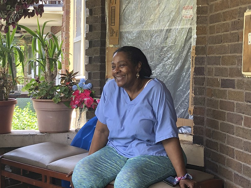 Deloris Knight of Detroit, Mich., sits on her front porch, Wednesday, July 17, 2019, as she prepares for the heat wave that will descend upon Detroit and a wide section of the Midwest. Knight said she will keep the heat out of her Eastside Detroit home by keeping her doors and curtains closed while running the small window air conditioner in the living room. "We have a couple of big fans. We have ceiling fans," Knight, 63, said while enjoying Wednesday's more comfortable 80-plus degree weather from her front porch. (AP Photo Corey Williams)