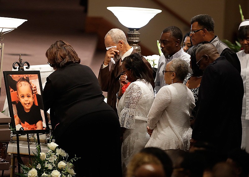 In this July 28, 2018, file photo, members of the Coleman family comfort each other at a casket during the showing for Horace Coleman, Belinda Coleman, Irvin Coleman, Angela Coleman and Maxwell Coleman in Indianapolis. Nine members of the Coleman family were killed in a duck boat accident on July 19, 2018, at Table Rock Lake near Branson Mo. A year after a duck boat sank and killed 17 people in a Missouri lake, the future of the tourist attraction remains a topic of debate. (AP Photo/Darron Cummings, File)