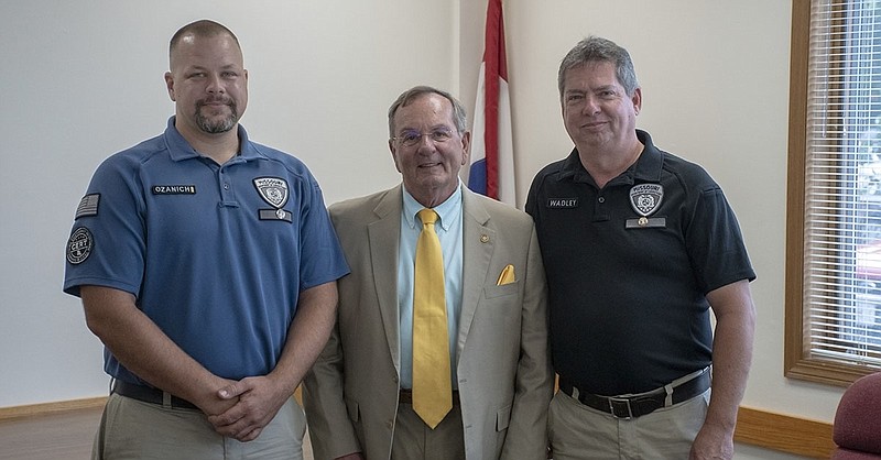 <p>Courtesy of Missouri Department of Corrections</p><p>Jefferson City Correctional Center officers Levi Ozanich, left, and Jerry Wadley, right, pictured with state Rep. Dave Griffith, R-Jefferson City, were recognized with 2019 Director’s Awards of Valor from the Missouri Department of Corrections for their efforts after a fellow prison staff member was assaulted by a prisoner July 27, 2018.</p>