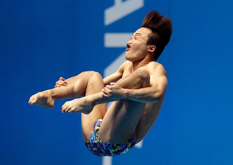 South Korea's Woo Haram performs his routine in the men's 3m springboard diving final at the World Swimming Championships in Gwangju, South Korea, Thursday, July 18, 2019. (AP Photo/Lee Jin-man)