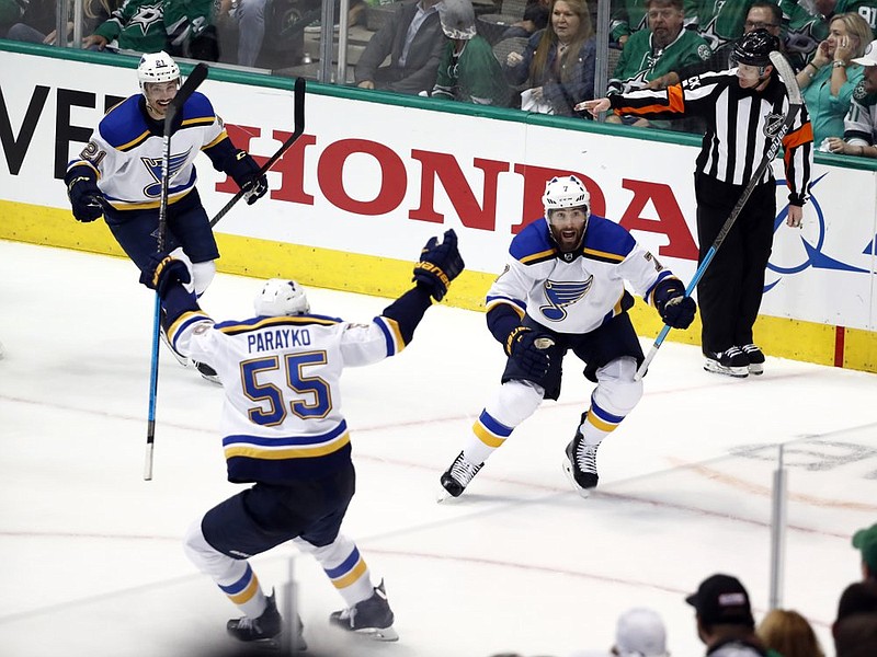 St. Louis Blues' Tyler Bozak (21), Colton Parayko (55) and Pat Maroon (7) celebrate a goal by Maroon against the Dallas Stars in the third period of Game 3 of an NHL second-round hockey playoff series in Dallas, Monday, April 29, 2019.