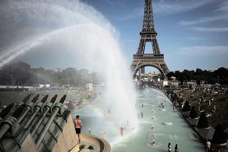 People cool off in the fountains of the Trocadero gardens, in front of the Eiffel Tower, in Paris, Friday, June 28, 2019. Schools are spraying kids with water and nursing homes are equipping the elderly with hydration sensors as France and other nations battle a record-setting heat wave baking much of Europe. On Thursday, July 18, 2019, the U.S. National Oceanic and Atmospheric Administration announced that June averaged 60.6 degrees (15.9 Celsius), about 1.7 degrees (0.9 Celsius) warmer than the 20th century average. It beat out 2016 for the hottest June with records going back to 1880. (AP Photo/Lewis Joly)