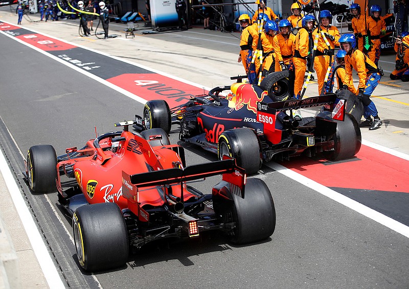 Ferrari driver Charles Leclerc of Monac, left, tries to overtake Red Bull driver Max Verstappen of the Netherland's after a pit service, during the British Formula One Grand Prix at the Silverstone racetrack, Silverstone, England, Sunday, July 14, 2019. (Photo Matthew Childs/Reuters Pool Via AP)