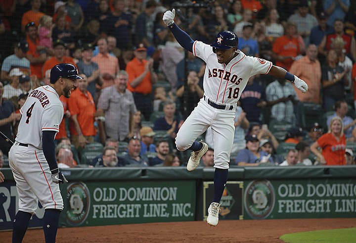 Houston Astros' Tony Kemp (18) celebrates his solo home run against the Texas Rangers as teammate George Springer (4) looks on in the sixth inning of a baseball game Saturday, July 20, 2019, in Houston. (AP Photo/Richard Carson)