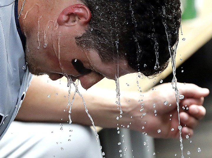San Diego Padres' Hunter Renfroe cools off in the dugout after hitting a solo home run against the Chicago Cubs during the fifth inning of a baseball game in Chicago, Saturday, July 20, 2019. (AP Photo/Nam Y. Huh)