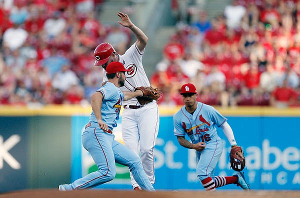 Cardinals shortstop Paul DeJong tags out Jesse Winker of the Reds during Saturday night's game in Cincinnati.