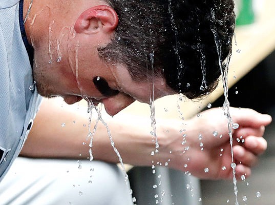 Hunter Renfroe of the Padres cools off in the dugout after hitting a solo home run during Saturday's game against the Cubs in Chicago.